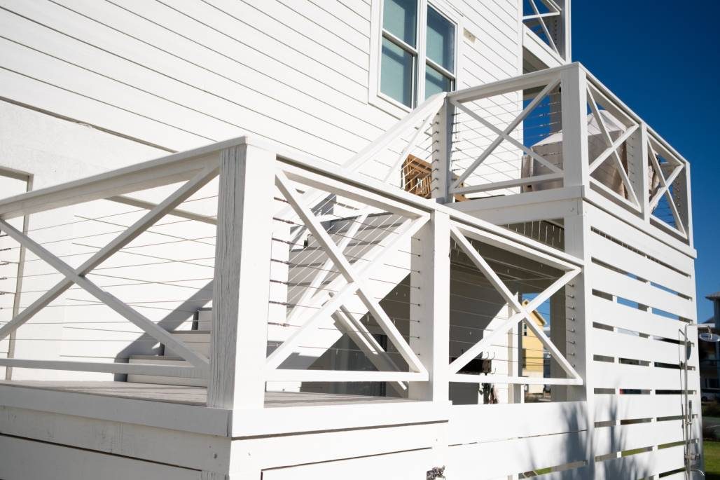 White X-brace deck railing with Ram Tail stainless cable infill panels.