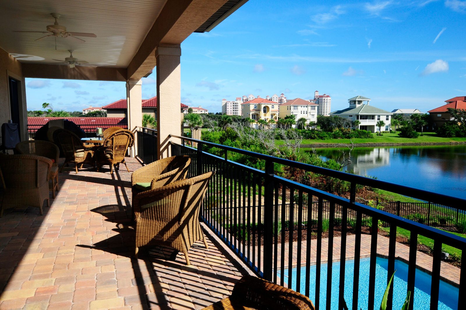 Black Westbury aluminum railing on a balcony overlooking a pool and lagoon.